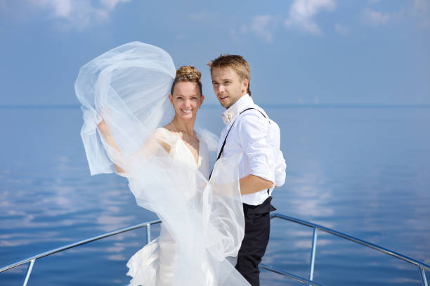Happy bride and groom hugging on a yacht