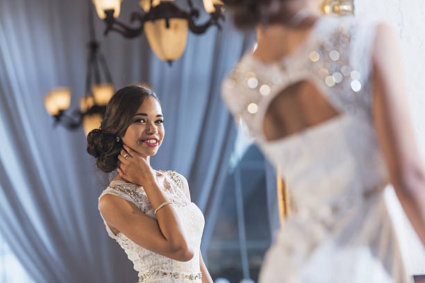 Young mixed race woman in elegant white dress Portrait of a mixed race teenage girl wearing an elegant white dress. She is ready for a special occasion, perhaps her prom or birthday party. prom dress stock pictures, royalty-free photos & images