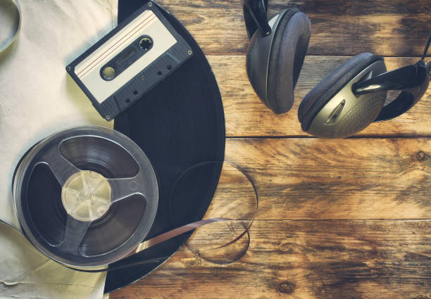 istock old vinyl record, audio cassette, tape bobbin and headphones 638963330