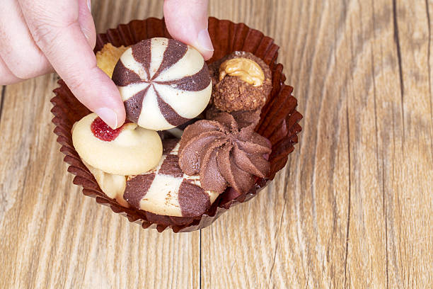 istock hand picking homemade cookies 638963516