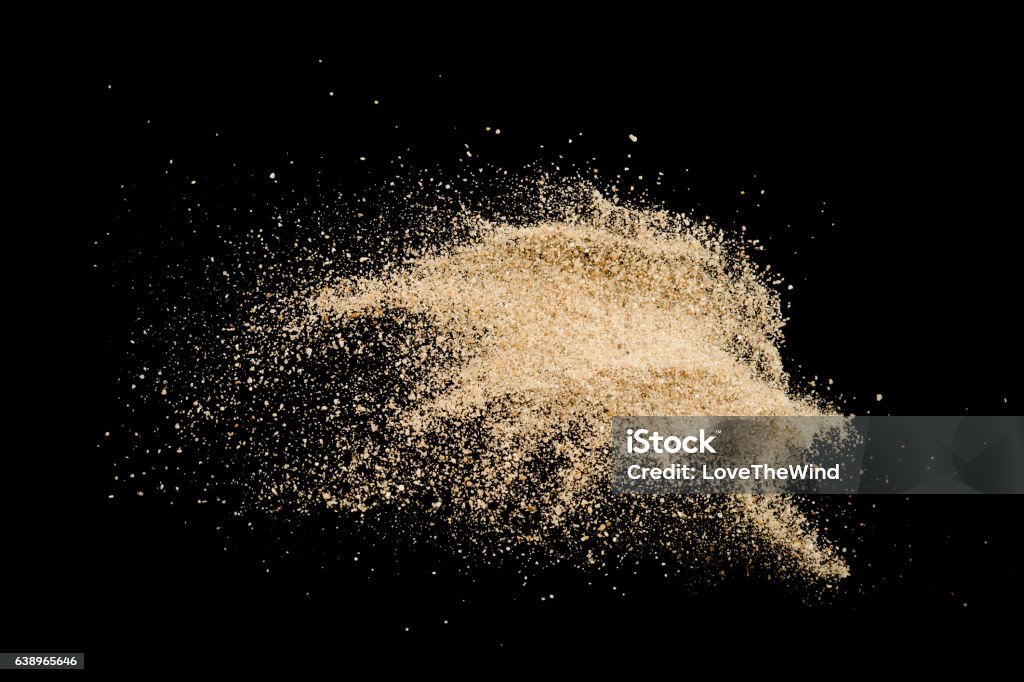 Sand explode on black background ,stop motion Sand Stock Photo