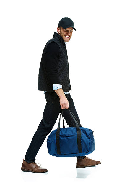 istock Smiling man holding gym bag and walking 638967236