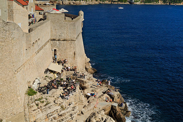 Dubrovnik, Croatia - October 22, 2016: Tourist having a cafe visit on the cliffs outside the Dubrovnik bailey