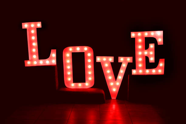 istock Word love from big, red letters with glowing light bulbs 638975794