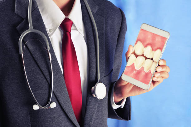 istock dentist hold smart phone 638976388