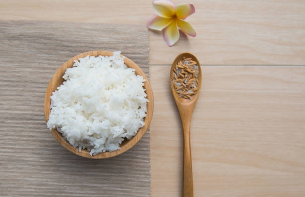 istock Cooked rice in a wooden bowl and spoon , paddy 638976602