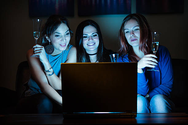 Three girlfriends, drunk, drinking champagne, celebrating, watch