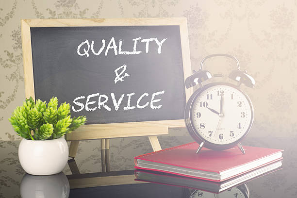 istock Quality And Service on blackboard with clock and flare 638979612
