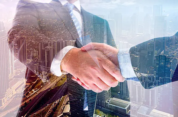 Photo of Business handshake double exposure