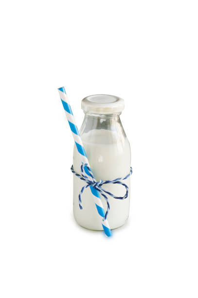 istock Milk bottle with striped straw. Cow's milk isolated on white. 638988926