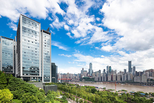 modern buildings near river in chongqing in blue cloudy sky