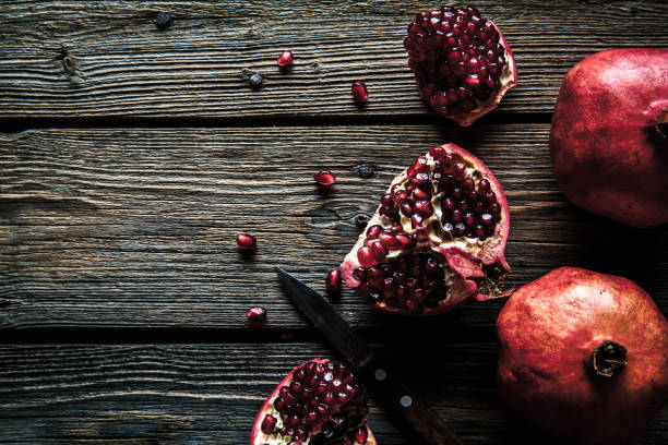 istock Fresh pomegranates on wooden background. 638990580