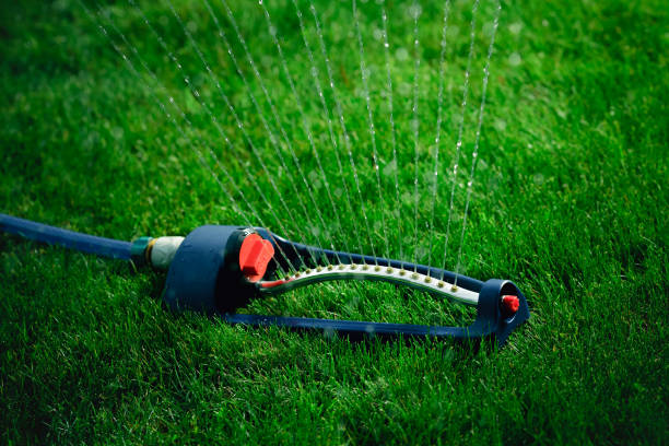 istock Lawn sprinkler spaying water over green grass. 638992918