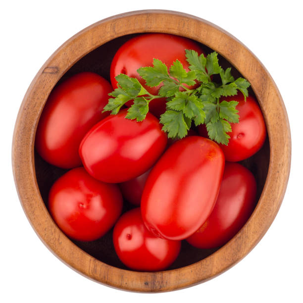 istock Fresh tomatoes in wood bowl on white background. 638994828