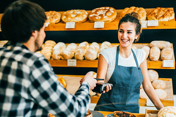 istock Young man making a contactless payment at a bakery 638995396