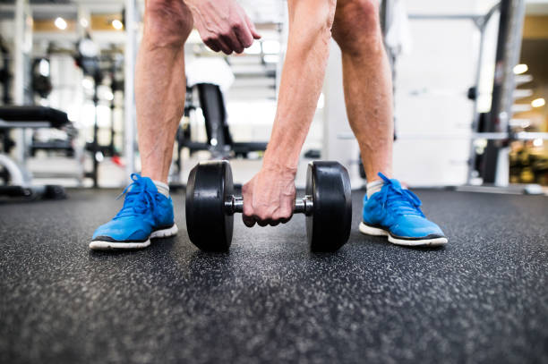 istock Unrecognizable senior man in gym working out with weights 638995732