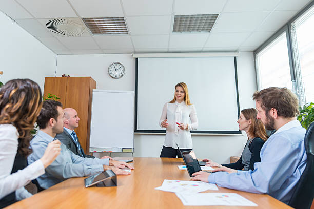 istock Young woman presenting ideas to his business team 638995926