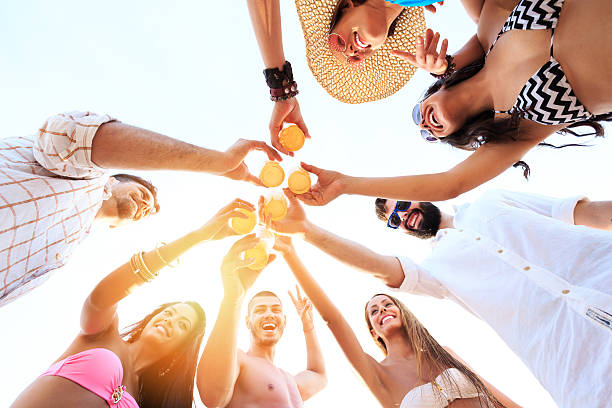 istock Carefree friends cheering with beer on beach 638996140