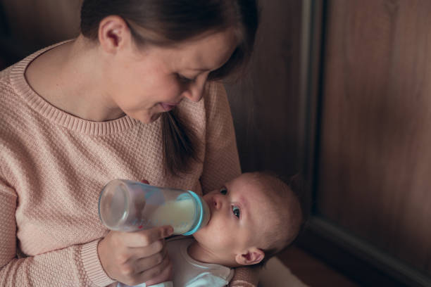 istock Mommy bottle feeding a baby boy 638998706
