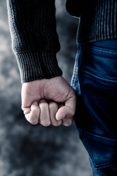 istock young man clenching his fist 639000576