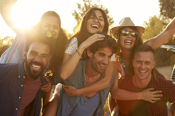 istock Three couples having fun piggybacking at sundown 639000854
