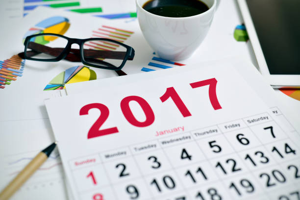 istock eyeglasses, coffee, tablet charts and 2017 calendar 639000888