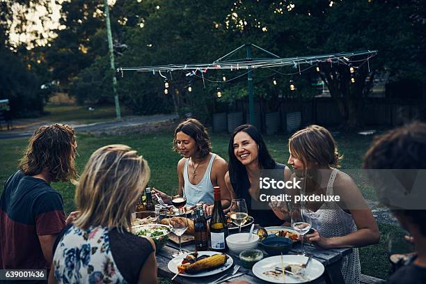 Sitting Down With Friends And Family For A Nightly Meal Stock Photo - Download Image Now