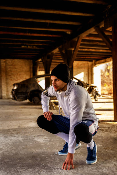 istock Young man stretching his muscles in old warehouse 639002512