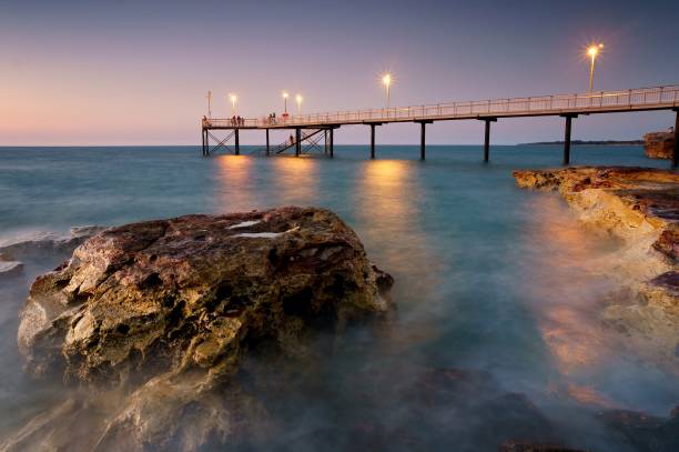 Nightcliff Jetty, Darwin NT Australia Sunset at Nightcliff Jetty in Darwin Northern Territory Australia during high tide with rocks surrounded by water. darwin nt stock pictures, royalty-free photos & images
