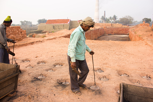 Two worker work at a brick factory