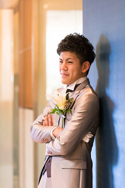 istock Japanese groom leaning on wall with confidence 639004552