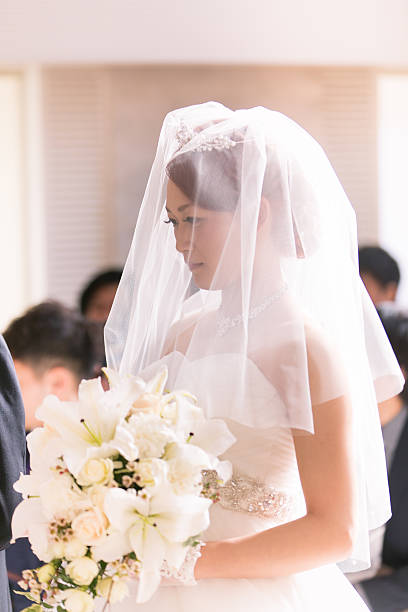 istock Bride walking forward in chapel at wedding ceremony 639004934