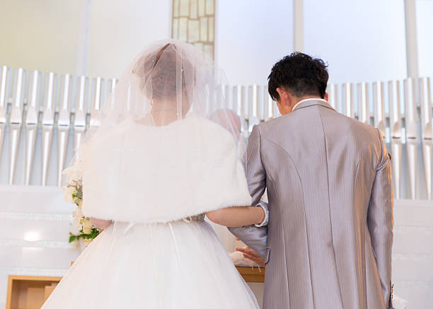 istock Bride and groom standing in chapel 639005146