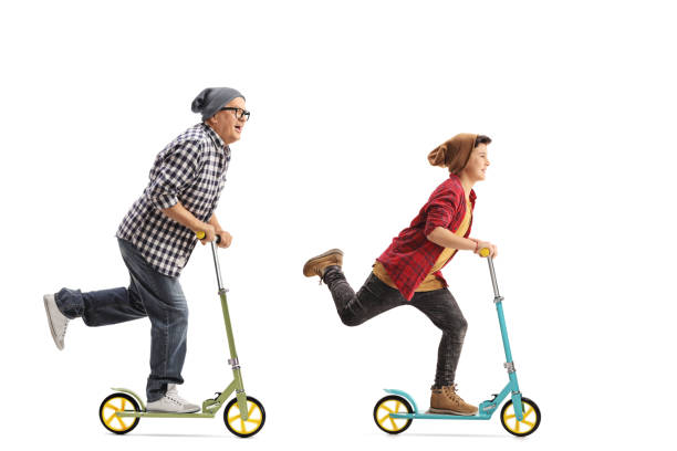 istock Mature hipster and a boy riding scooters 639005446