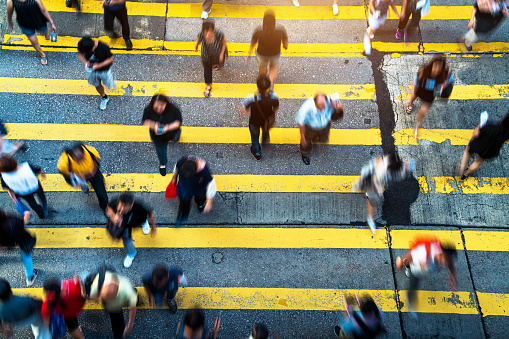 Pedestrians crossing street in Hong Kong, China