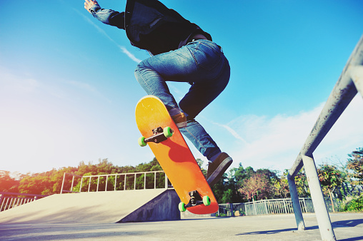 closeup of skateboarder skateboarding on skatepark