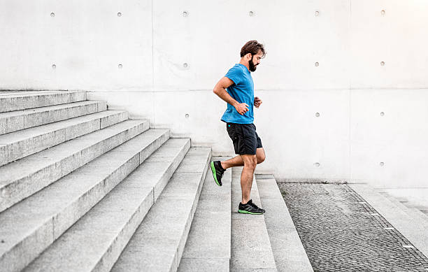 istock sporty man running down steps in urban setting 639006828