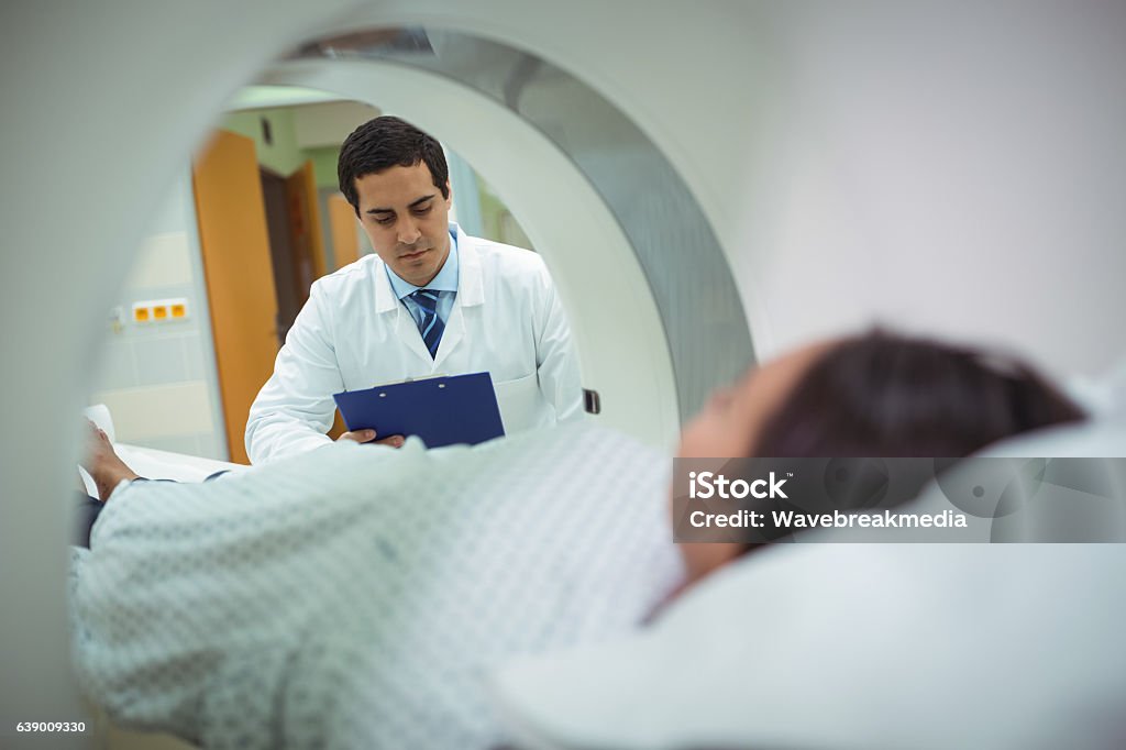 Patient undergoing CT scan test Patient undergoing CT scan test in the hospital MRI Scanner Stock Photo