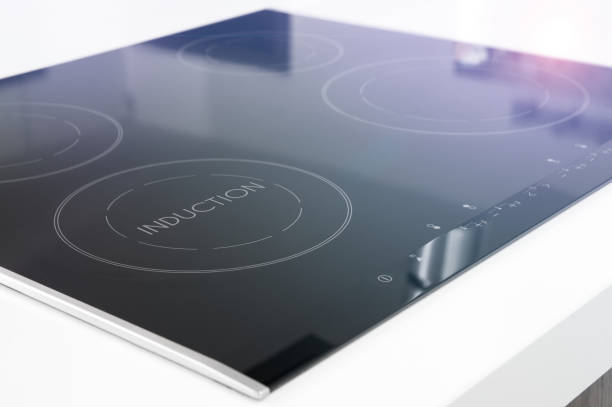 Modern black induction cooker on white countertop stock photo