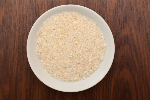 istock White plate with rice on wooden background 639011516