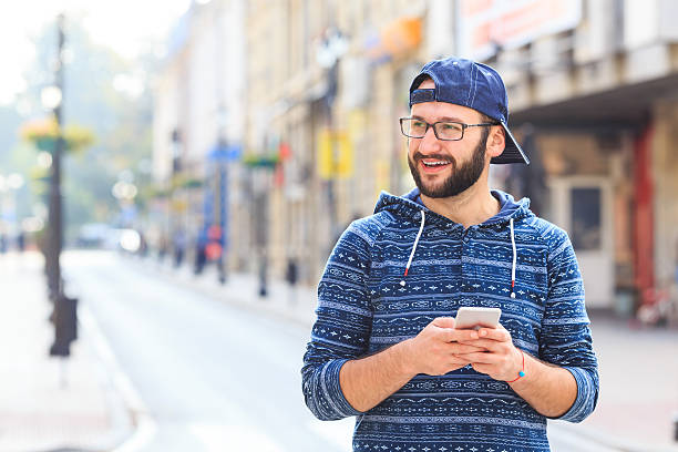 istock Young man using smart phone on street 639014712