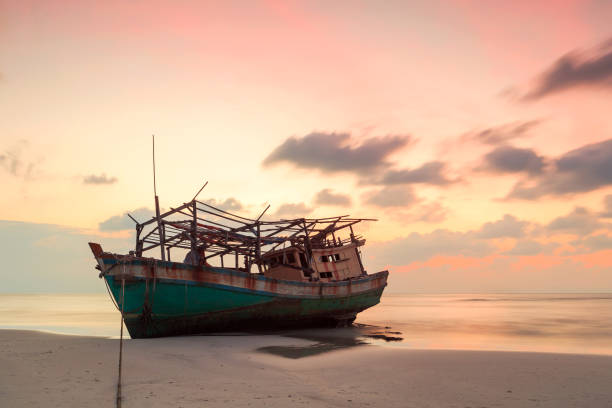 istock abandoned boat at beach in twilight 639014960