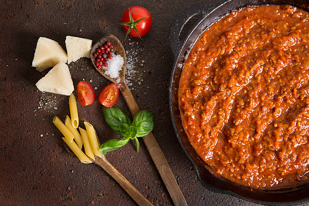 Cooking Bolognese Sauce Meat sauce in iron pan. bolognese sauce photos stock pictures, royalty-free photos & images