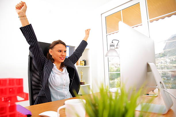 istock Businesswoman with computer cheering 639017426