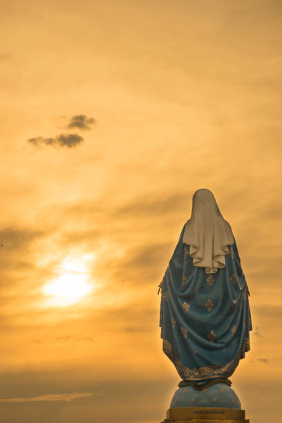istock Virgin mary statue warm tone sunset scene 639017766