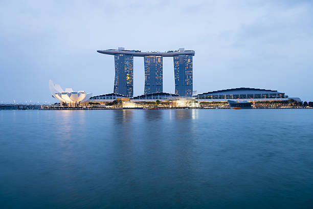 Singapore, Singapore - April 10, 2016: Late afternoon view of the Marina Bay Sands Hotel in Singapore in the centre. The ArtScience Museum is showing to the left.