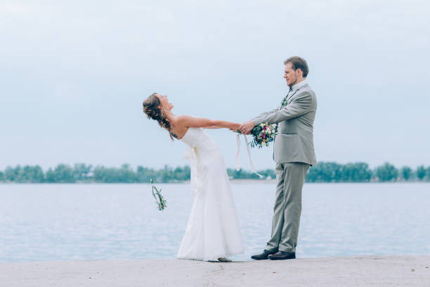 istock young groom and bride standing hugging on the background of 639017974