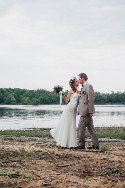istock young groom and bride standing hugging on the background of 639018420