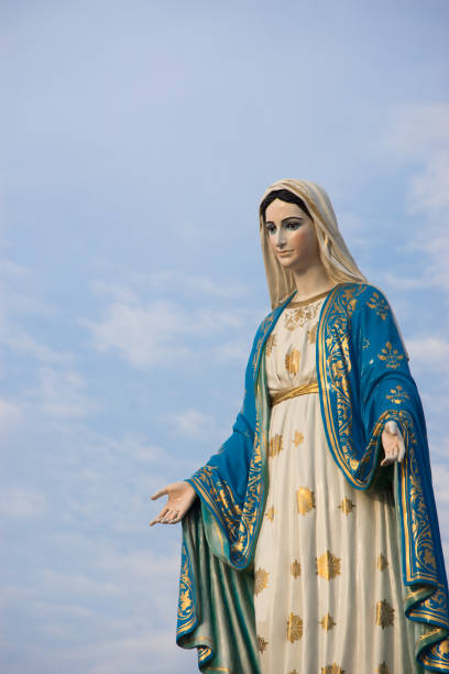 istock Virgin mary statue with blue sky background 639019176
