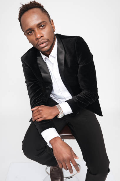 istock Attractive young african businessman sitting on stool 639019368